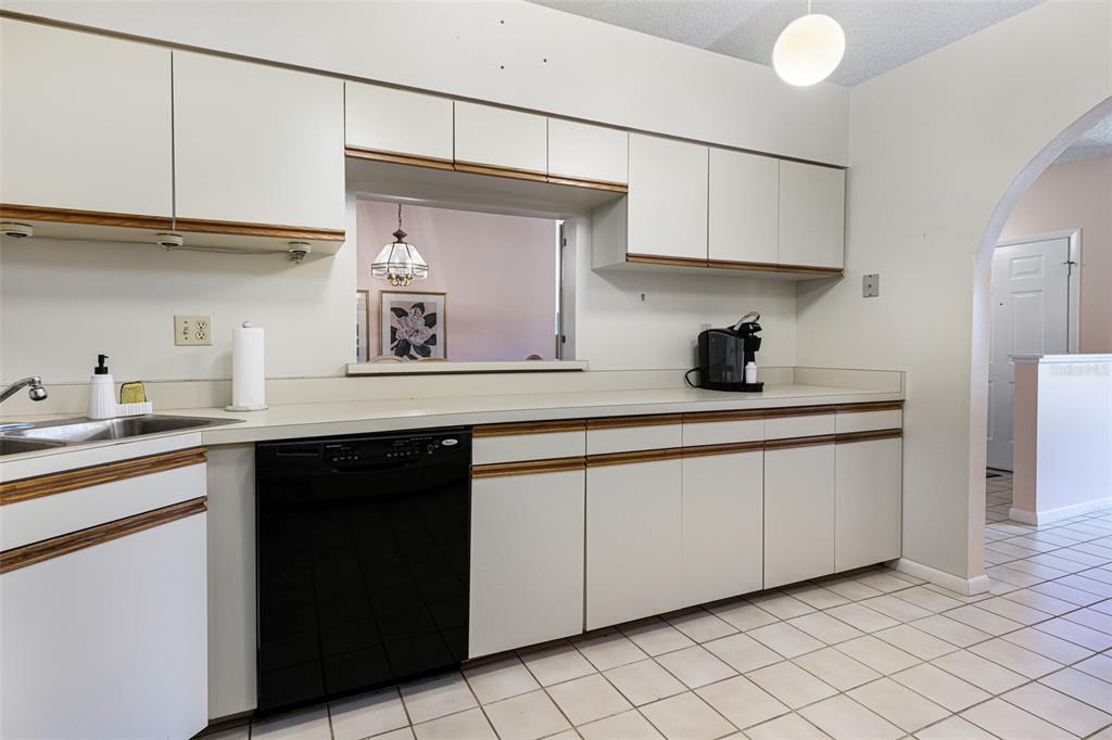 3041 Matecumbe Key Road, Unit 4 Punta Gorda, FL 33955 - Photo 24 of 33 a kitchen with stainless steel appliances granite countertop a sink and cabinets