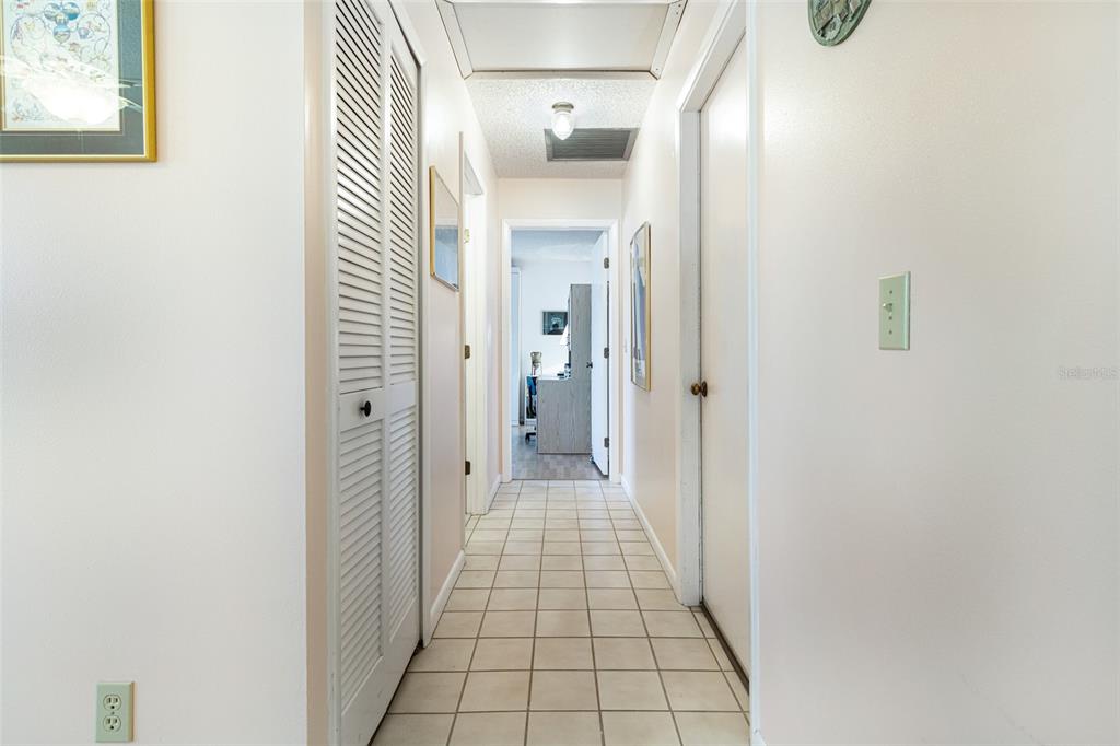 3041 Matecumbe Key Road, Unit 4 Punta Gorda, FL 33955 - Photo 25 of 33 a view of a hallway with wooden floor and a bathroom