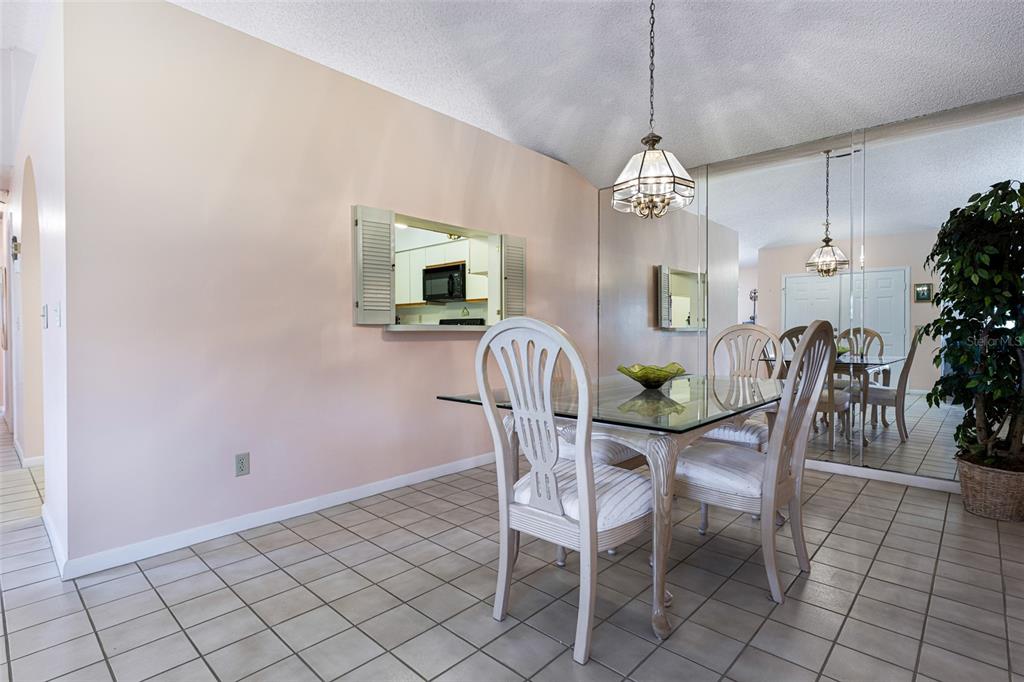 3041 Matecumbe Key Road, Unit 4 Punta Gorda, FL 33955 - Photo 8 of 33 a view of a dining room with furniture window and wooden floor