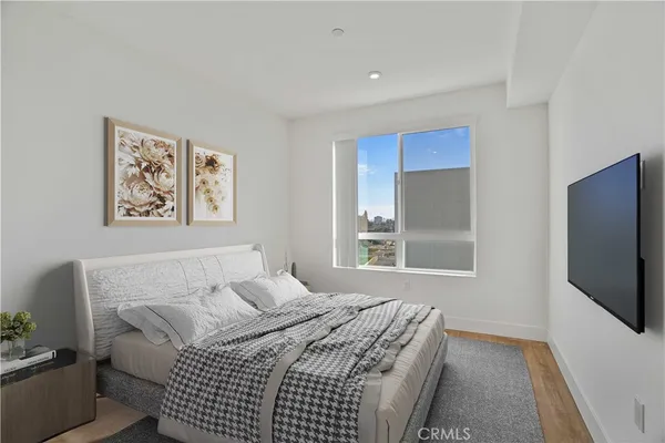 a bedroom with a bed and a flat screen tv