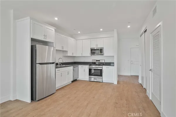 a kitchen with stainless steel appliances refrigerator and cabinets