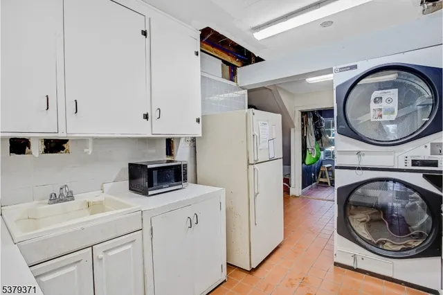 a kitchen with a stove a sink and a refrigerator