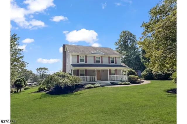 a view of a hallway with dining area and chandelier