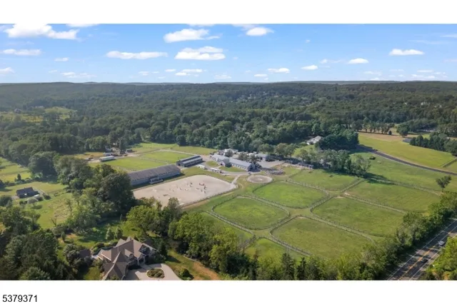 an aerial view of a house with a garden and lake view