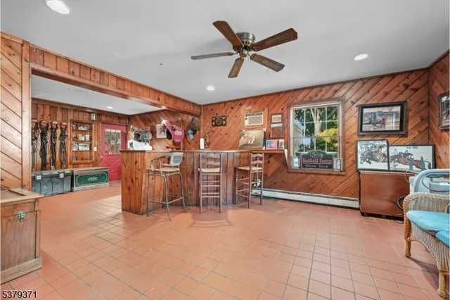 a view of a livingroom with furniture and a ceiling fan