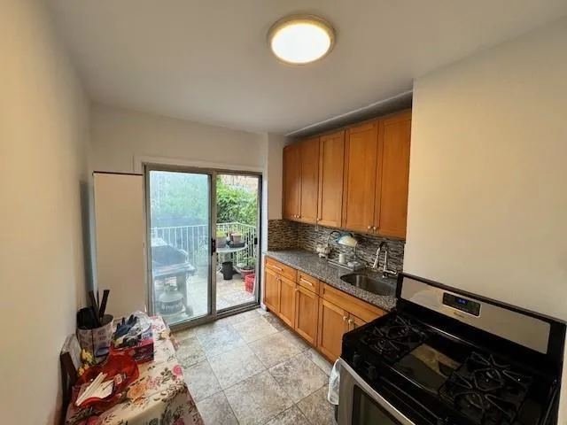 a kitchen with stainless steel appliances granite countertop a stove and a refrigerator