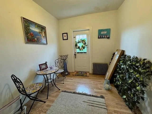 a view of a hallway with chairs and a potted plant