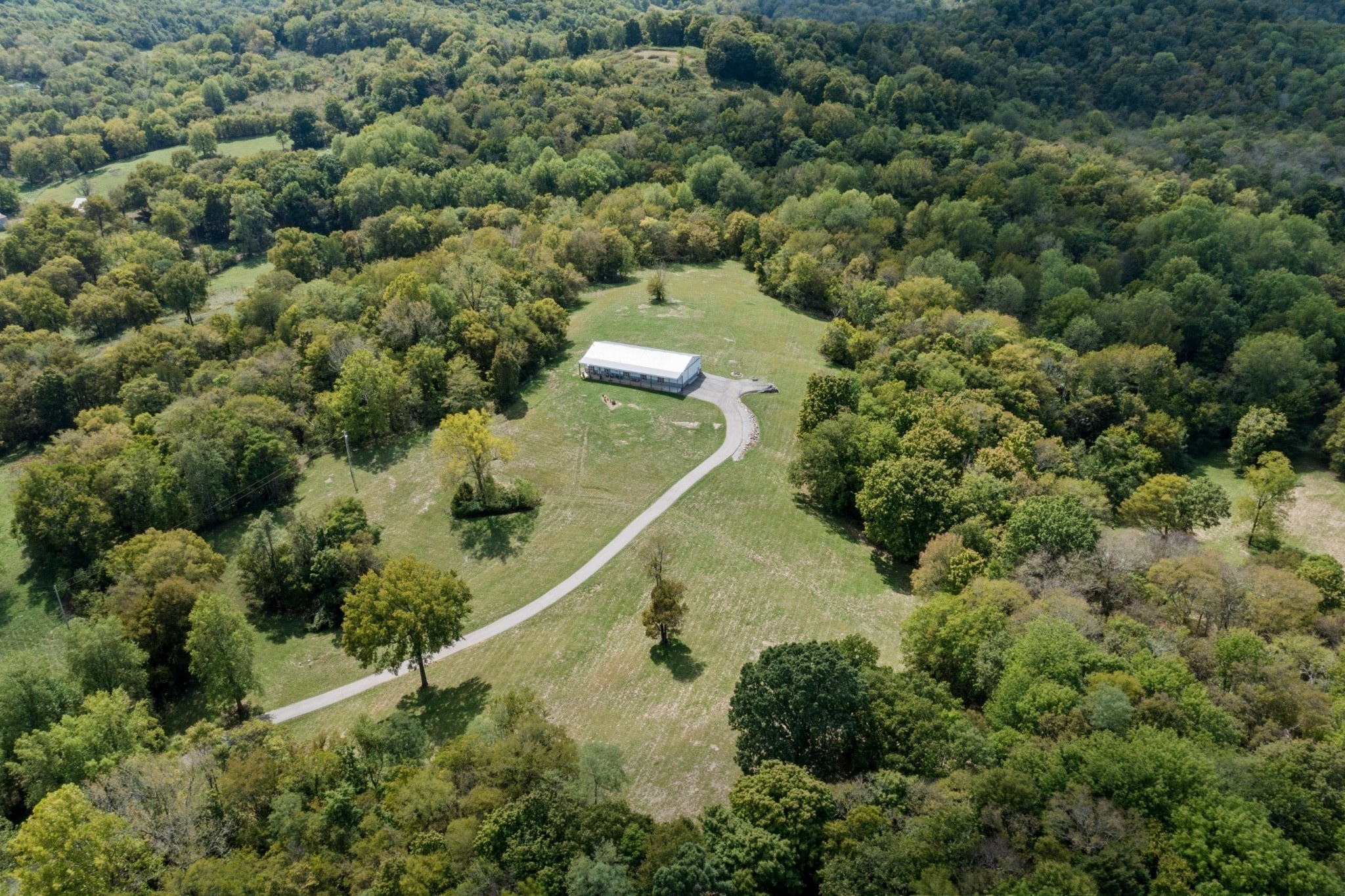 1818 Preacher Holt Road Mount Pleasant, TN 38474 - Photo 5 of 43 an aerial view of a house with a yard