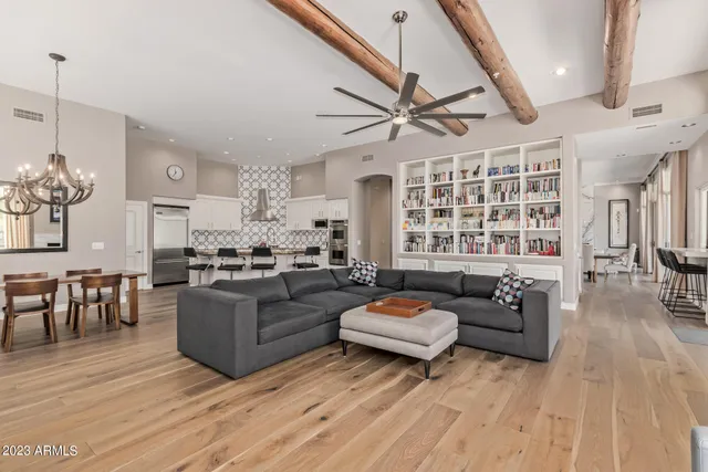 a view of empty room with wooden floor and windows