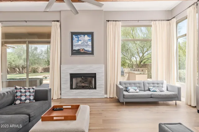 a living room with furniture a fireplace and a flat screen tv