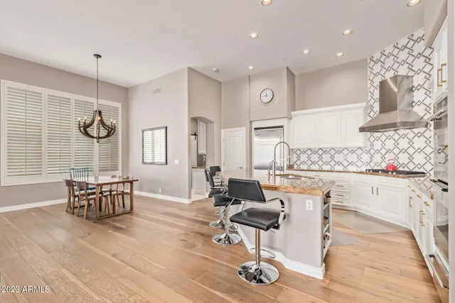 a living room with furniture a table and chair