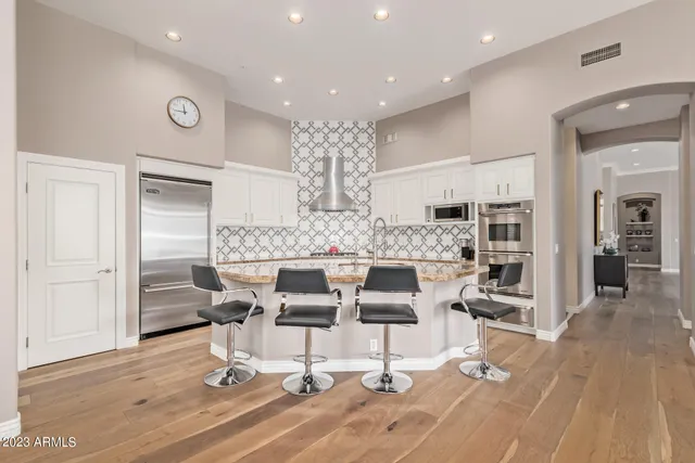 a living room with furniture a table and chair
