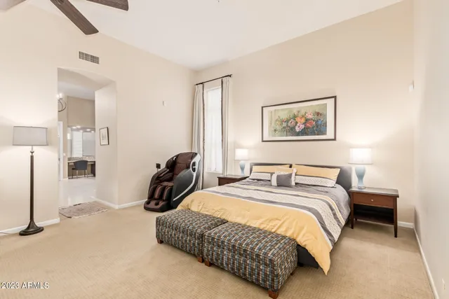 a bedroom with a bed and a television