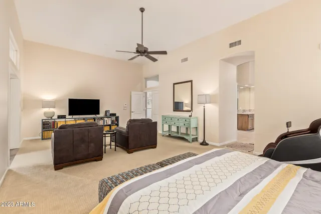 a living room with furniture a ceiling fan and a window