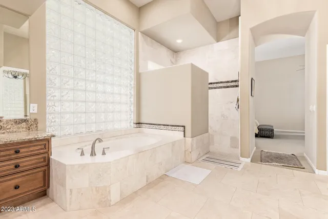 a bathroom with a granite countertop sink and a large mirror