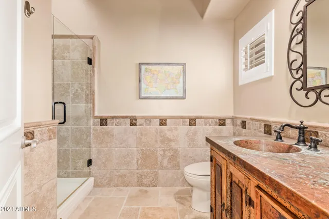 a large white kitchen with stainless steel appliances granite countertop a refrigerator and cabinets