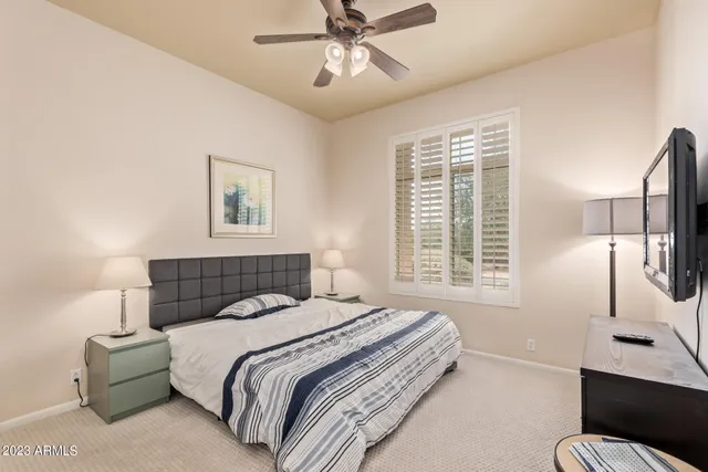 a bedroom with a bed window and a couch