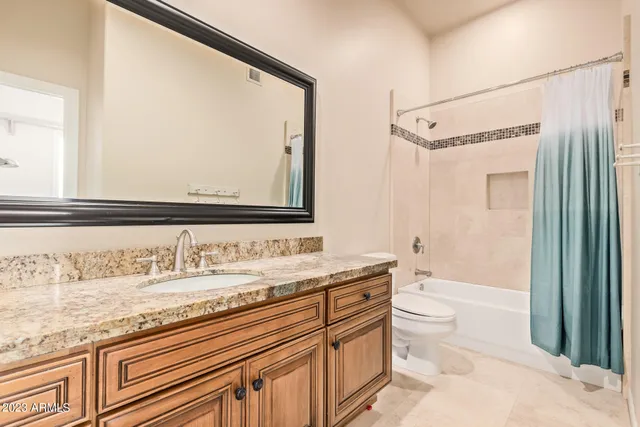 a kitchen with granite countertop cabinets and refrigerator