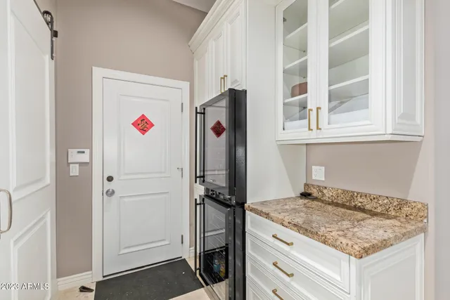 a kitchen with granite countertop cabinets and refrigerator