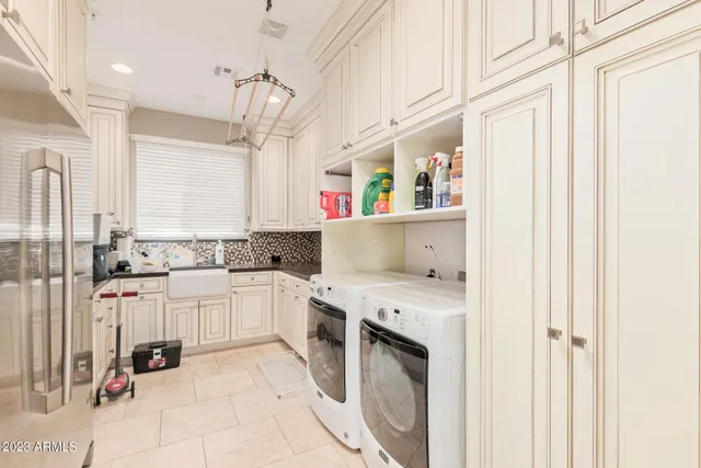 a kitchen with white cabinets and white appliances
