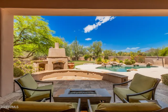 a view of a swimming pool and lounge chairs