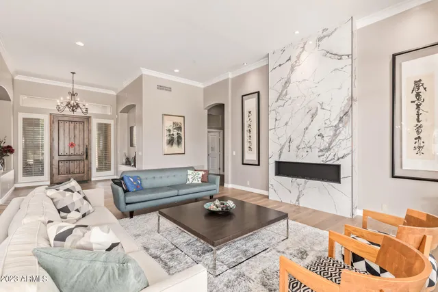 a living room with furniture and a floor to ceiling window