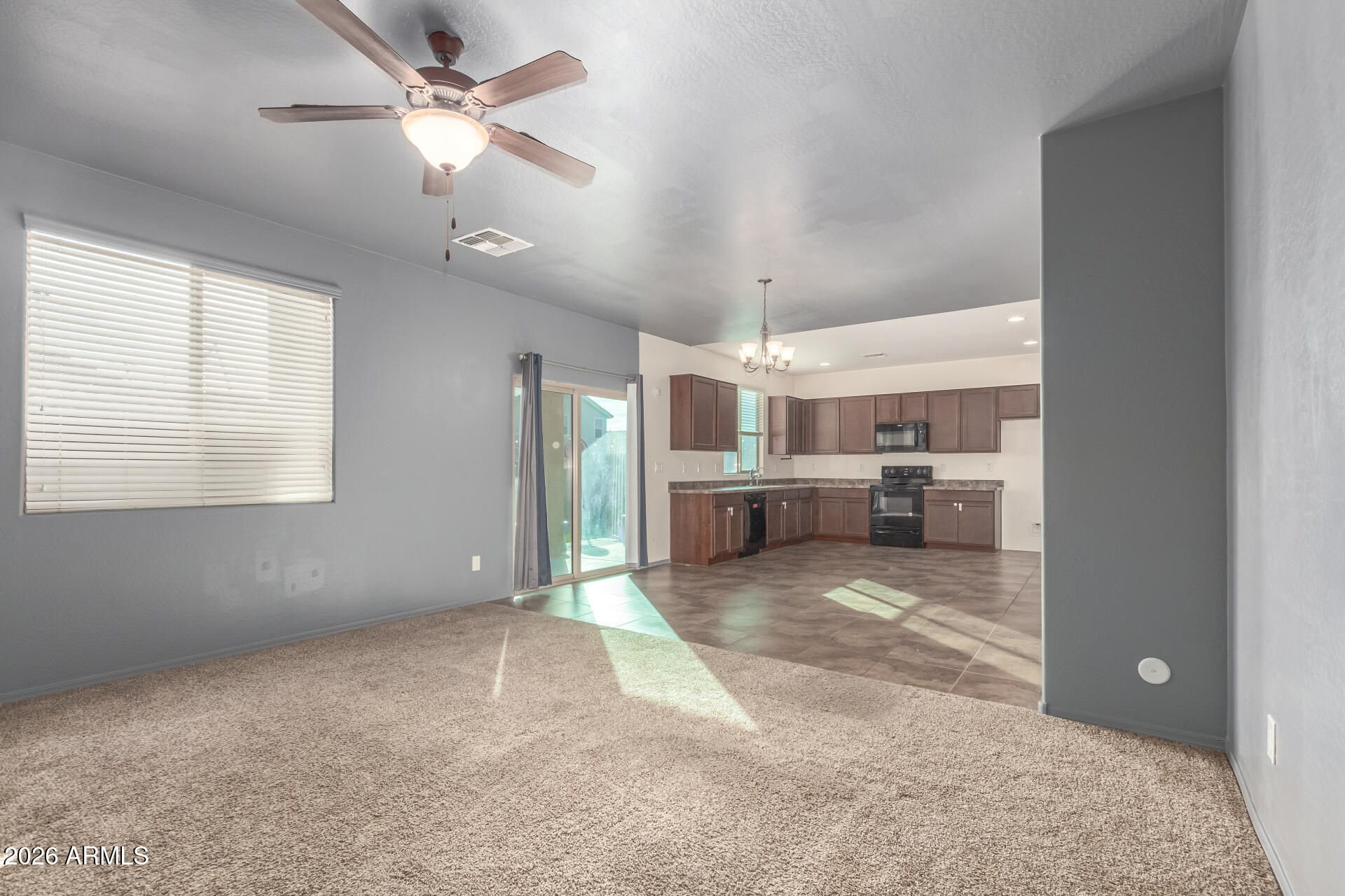 6203 West Evergreen Road Glendale, AZ 85302 - Photo 14 of 32 a view of a livingroom with a ceiling fan and window