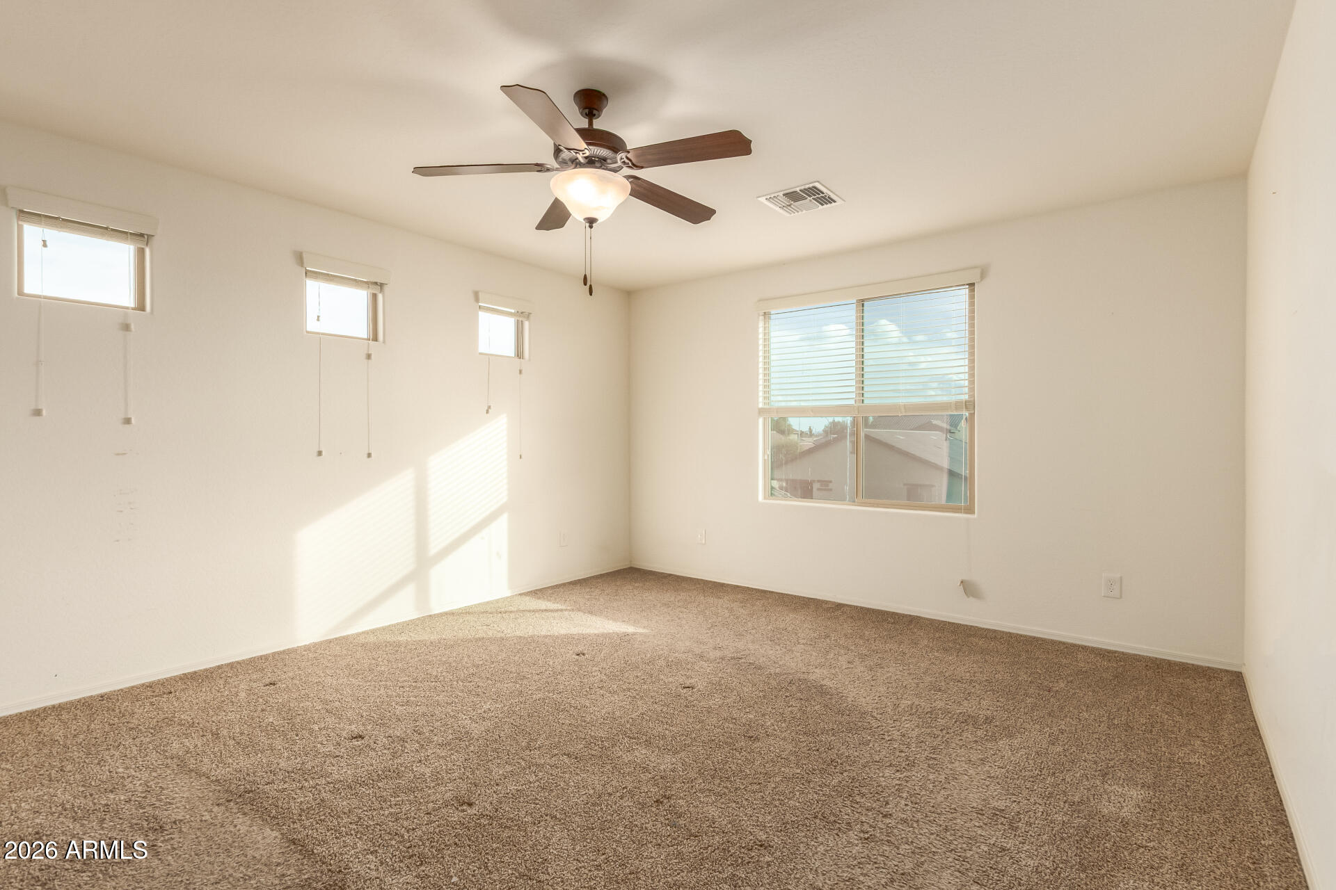 6203 West Evergreen Road Glendale, AZ 85302 - Photo 20 of 32 an empty room with windows and fan