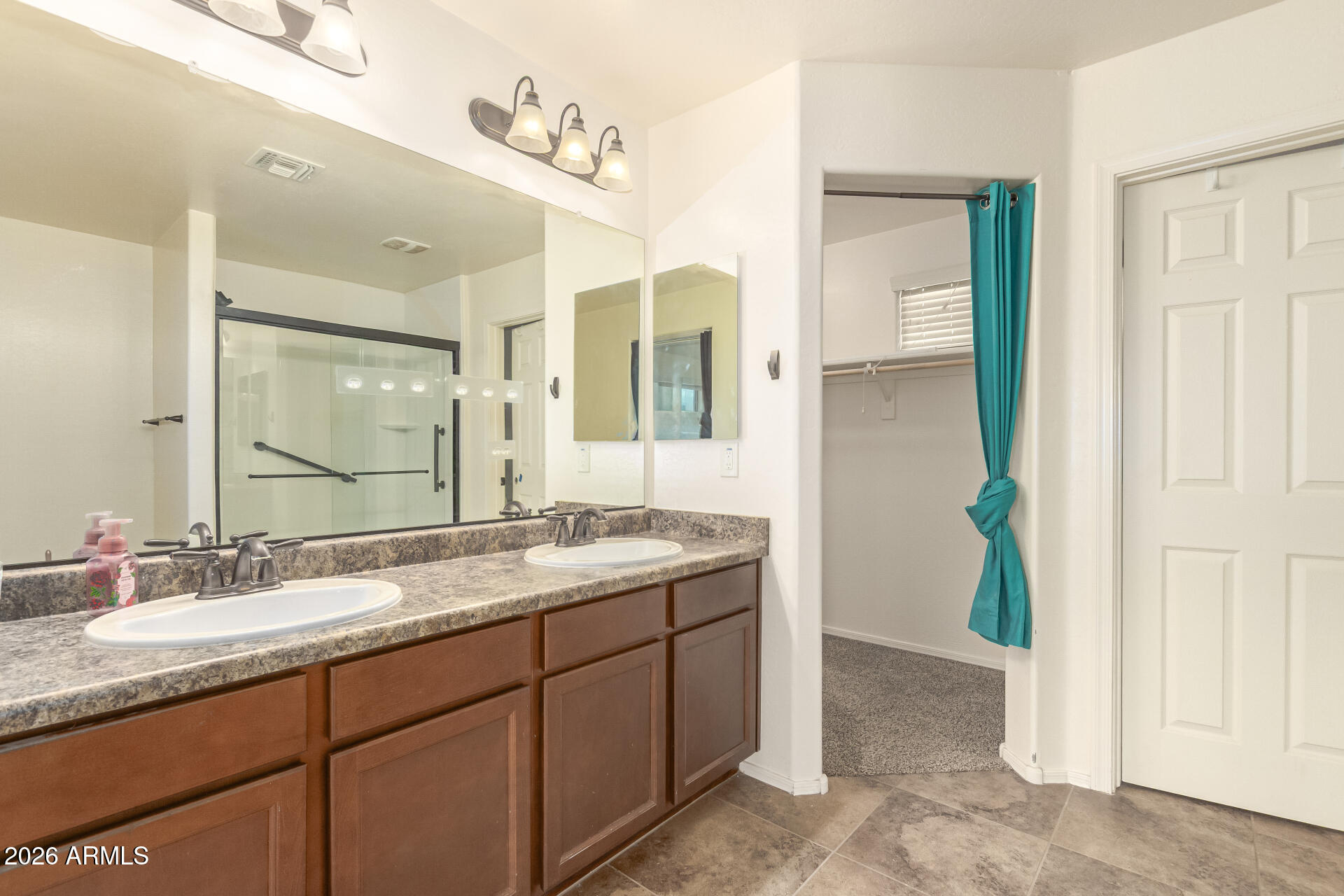 6203 West Evergreen Road Glendale, AZ 85302 - Photo 22 of 32 a bathroom with a granite countertop sink and a mirror