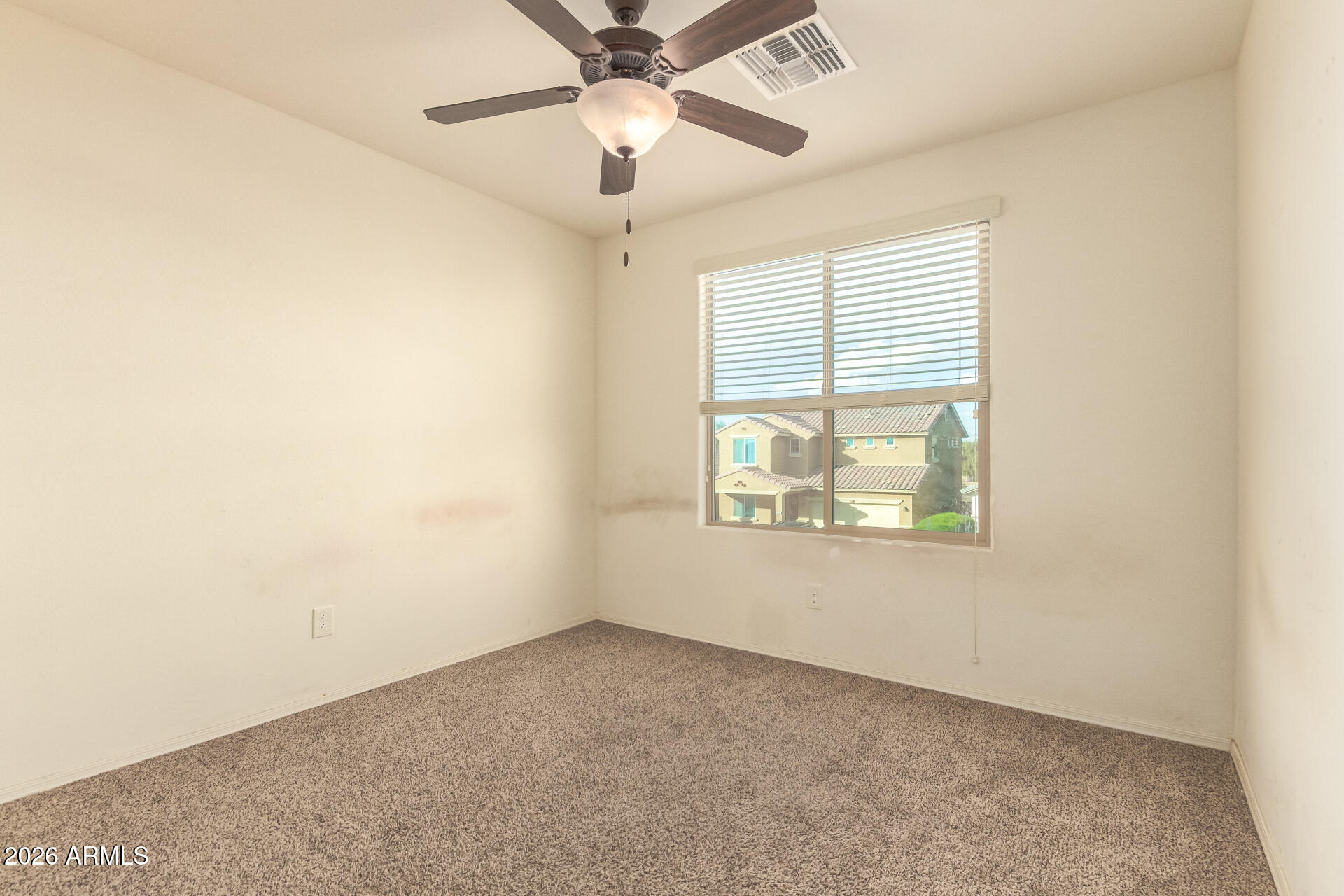 6203 West Evergreen Road Glendale, AZ 85302 - Photo 28 of 32 an empty room with a window and a fan