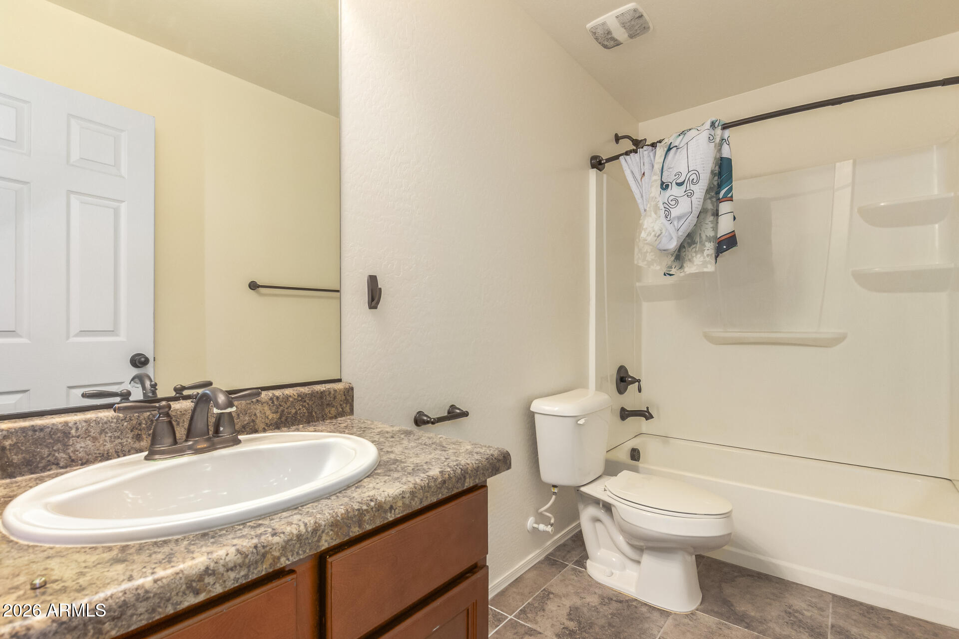 6203 West Evergreen Road Glendale, AZ 85302 - Photo 30 of 32 a bathroom with a granite countertop sink toilet and shower
