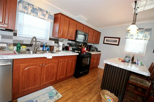 a kitchen with stainless steel appliances kitchen island granite countertop lots of counter top space