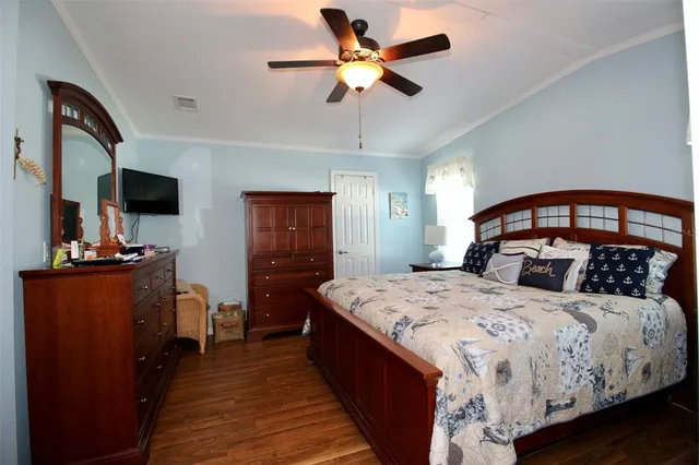 a bedroom with a bed a lamp and a dresser