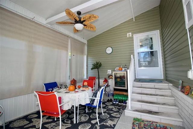 a dining room with furniture a rug and a chandelier