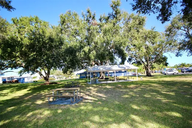 a view of an house with backyard and porch