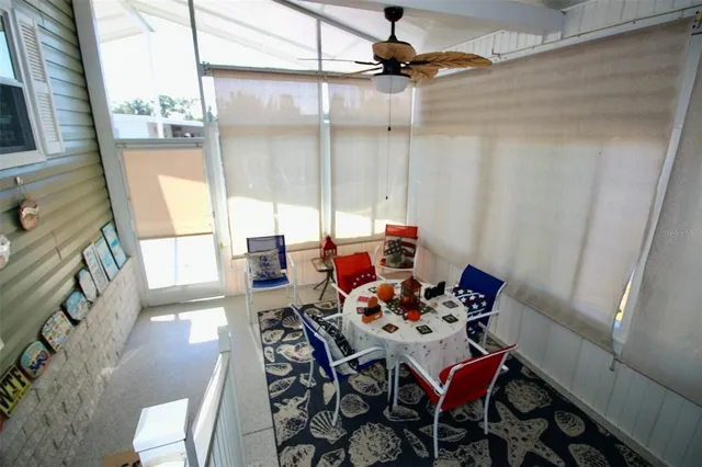 a living room with furniture a large window and a flat screen tv
