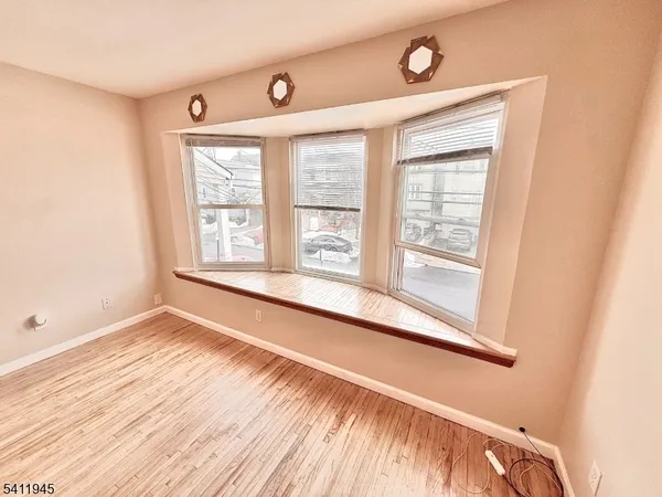 a view of a room with wooden floor