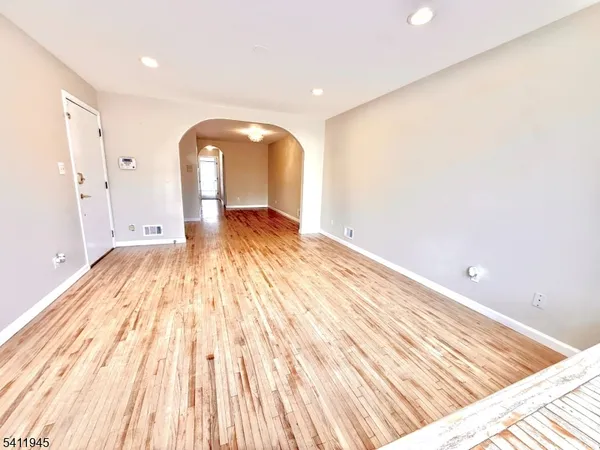 a view of a room with wooden floor and small space
