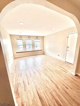 a large white kitchen with a sink a refrigerator and window