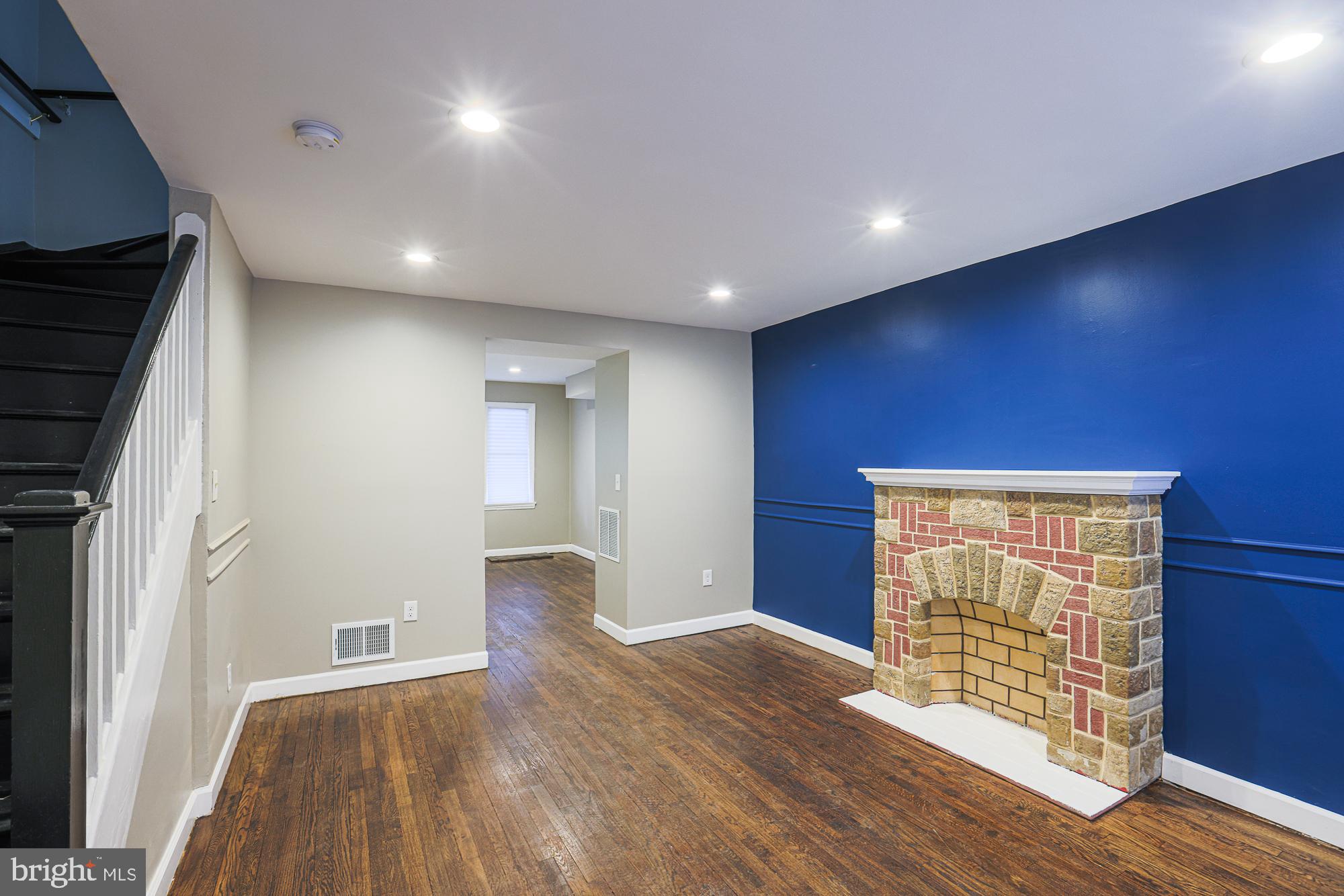2454 Terra Firma Road Baltimore, MD 21225 - Photo 12 of 44 an empty room with wooden floor and windows