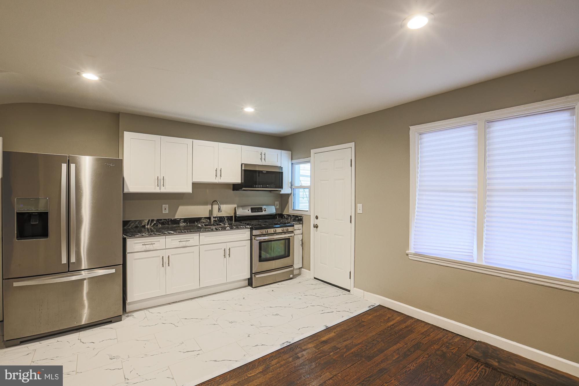 2454 Terra Firma Road Baltimore, MD 21225 - Photo 15 of 44 a kitchen with stainless steel appliances granite countertop a stove and a refrigerator