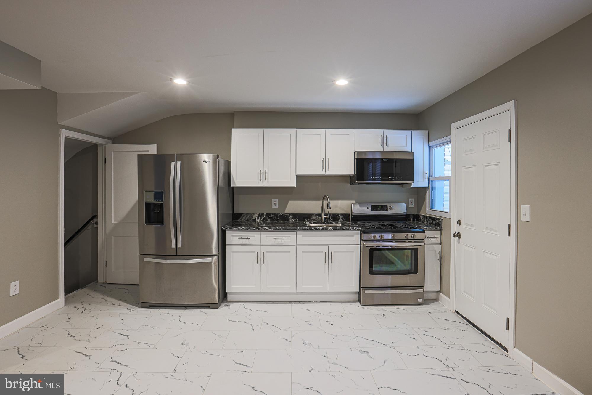 2454 Terra Firma Road Baltimore, MD 21225 - Photo 16 of 44 a kitchen with stainless steel appliances granite countertop a refrigerator and a stove top oven