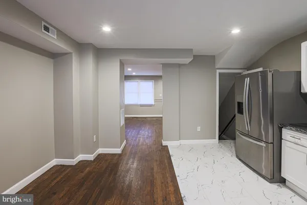 a view of a refrigerator in kitchen and wooden floor