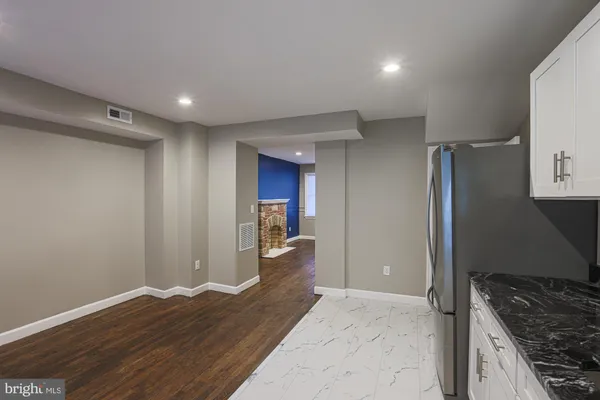 a view of a kitchen with a sink and a refrigerator