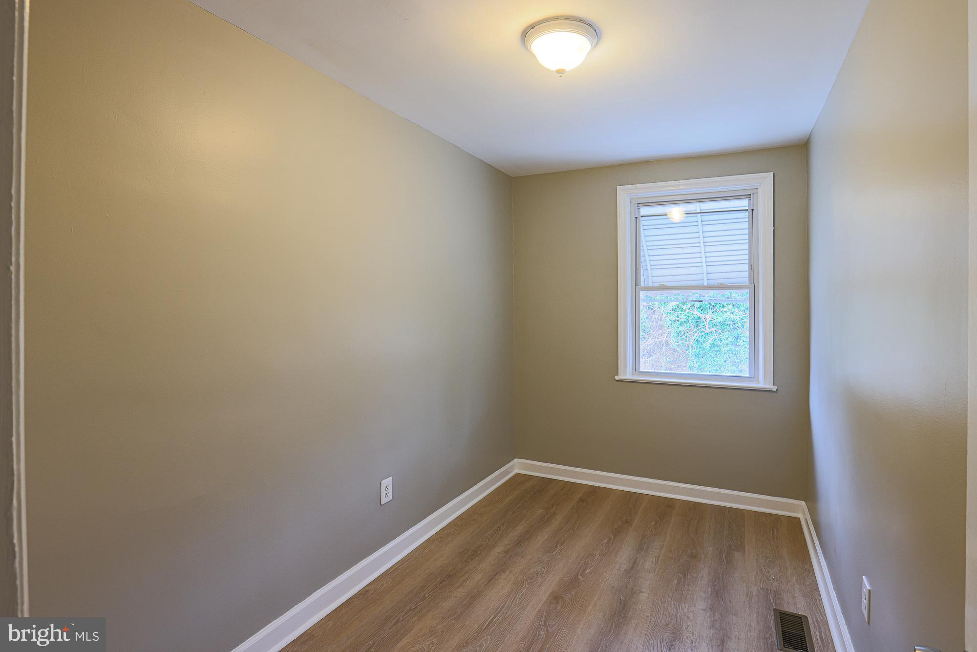 2454 Terra Firma Road Baltimore, MD 21225 - Photo 25 of 44 wooden floor in an empty room with a window