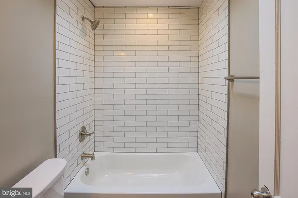 a bathroom with a bathtub and shower