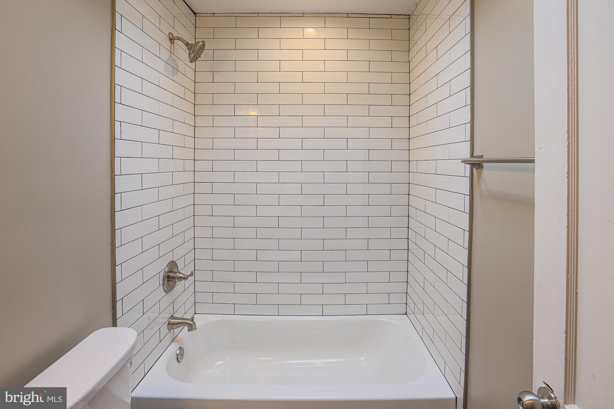 2454 Terra Firma Road Baltimore, MD 21225 - Photo 30 of 44 a bathroom with a bathtub and shower