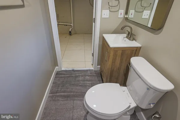 a white toilet sitting next to a bathroom sink