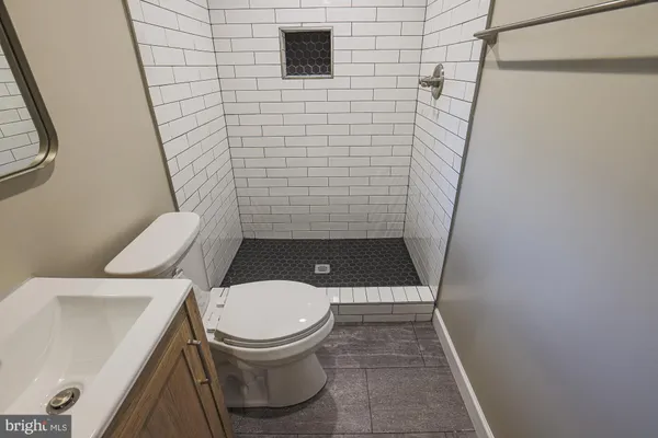 a bathroom with a toilet and a shower