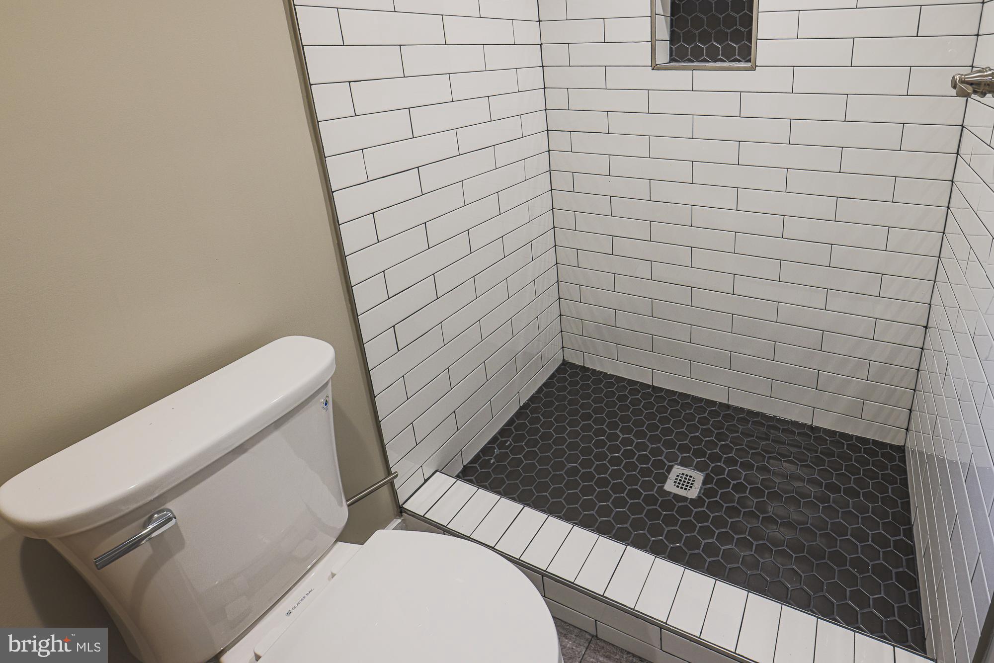 2454 Terra Firma Road Baltimore, MD 21225 - Photo 39 of 44 a bathroom with a granite countertop toilet and a sink